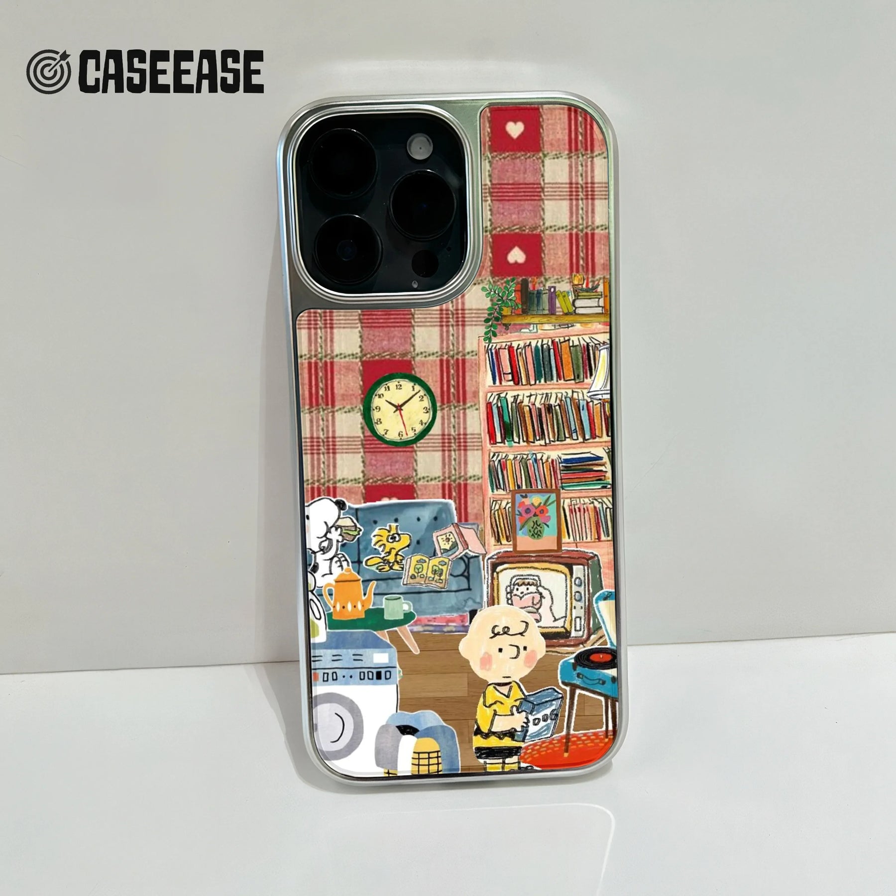 Angled close-up of silver phone case with red plaid cartoon room design