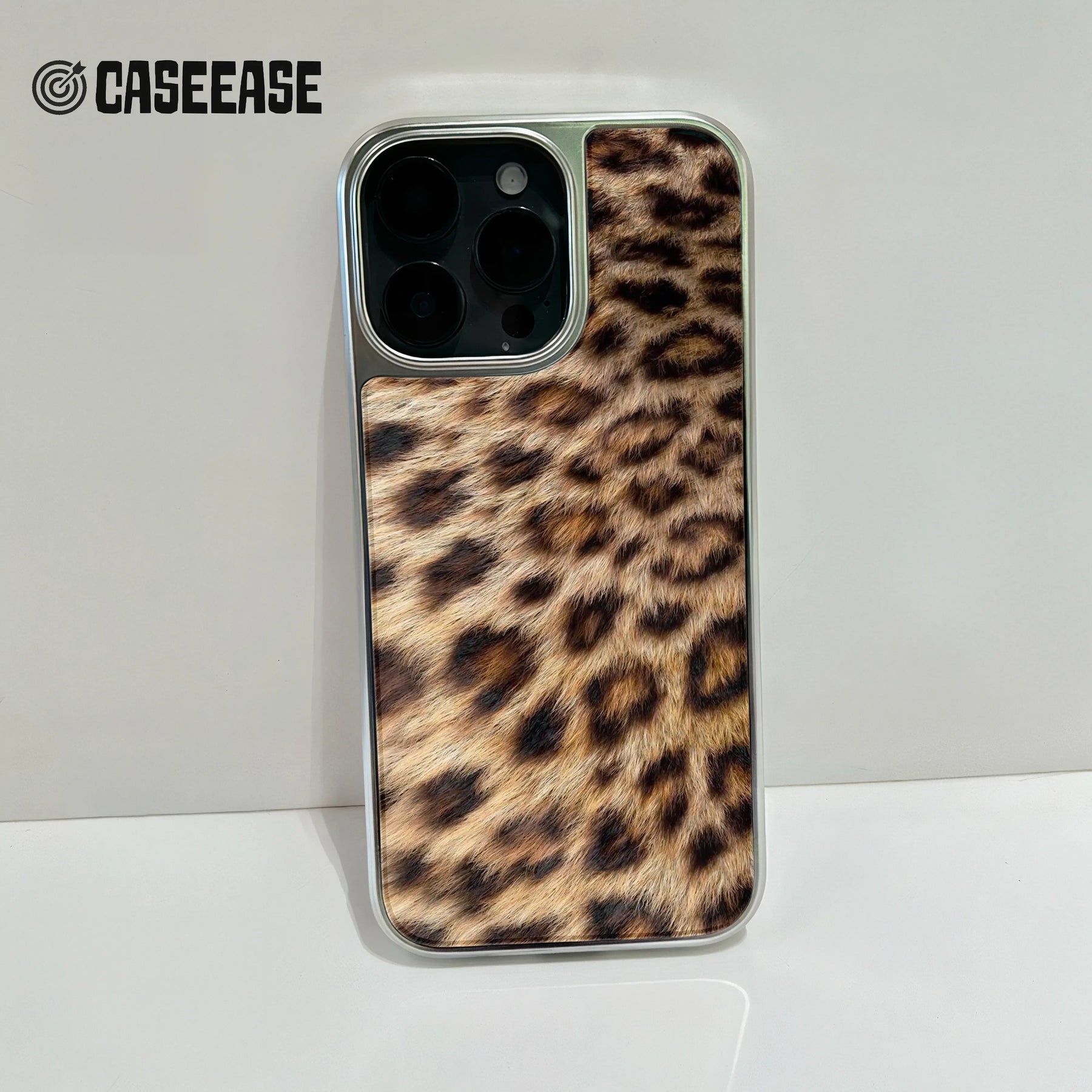 Silver phone case with brown leopard print back, close-up rear camera angle