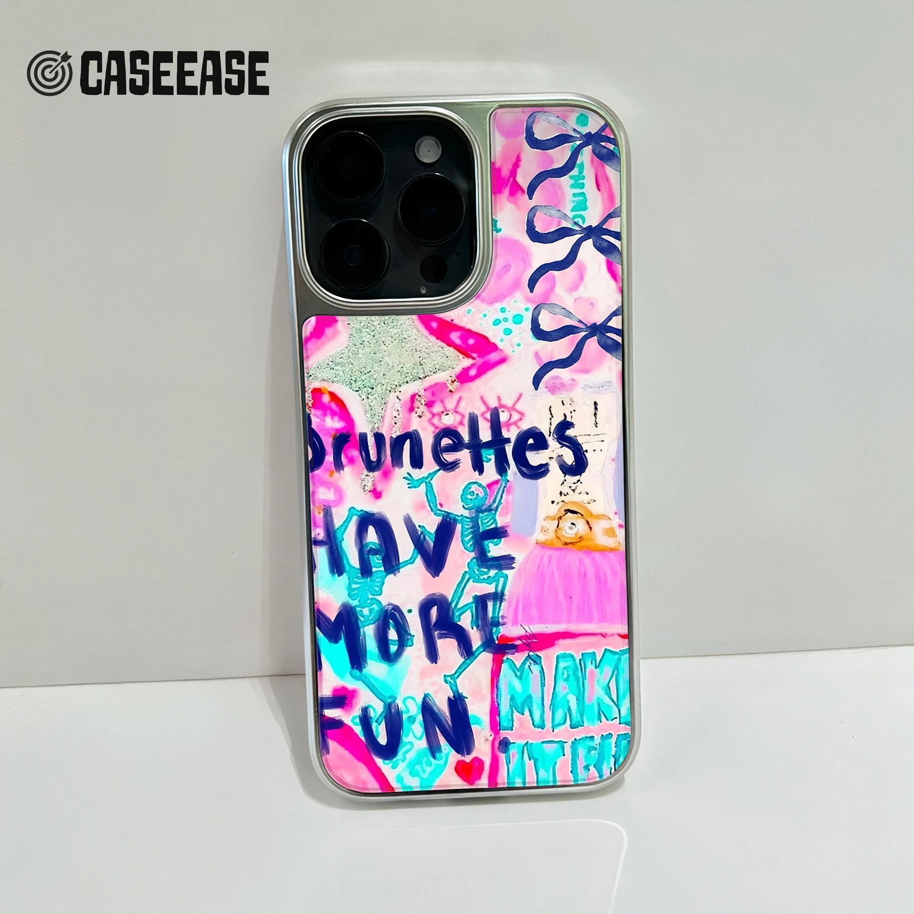 Silver phone case with pink blue graffiti design, rear camera close-up product shot