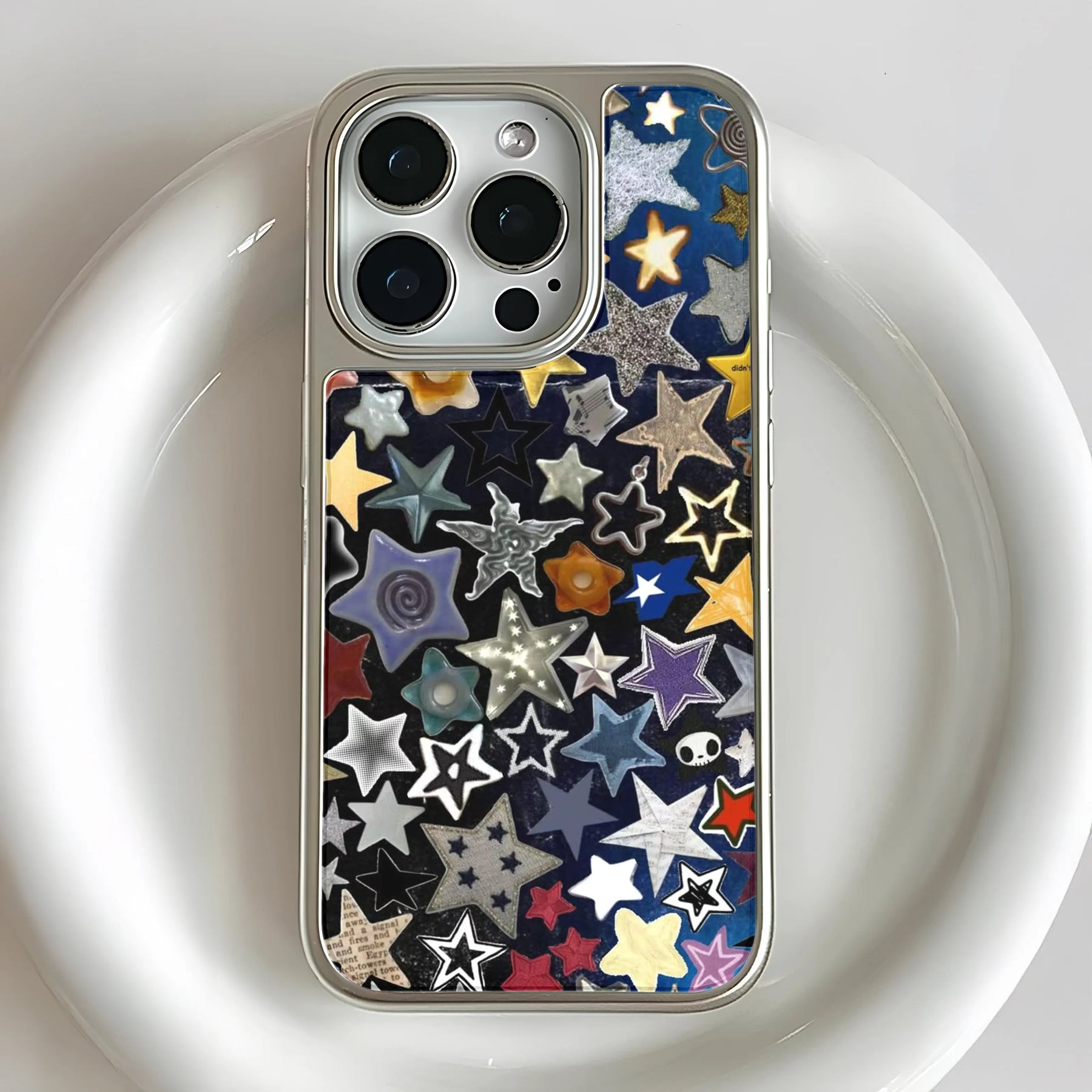 Close-up rear view of silver iPhone in clear case with colorful star pattern