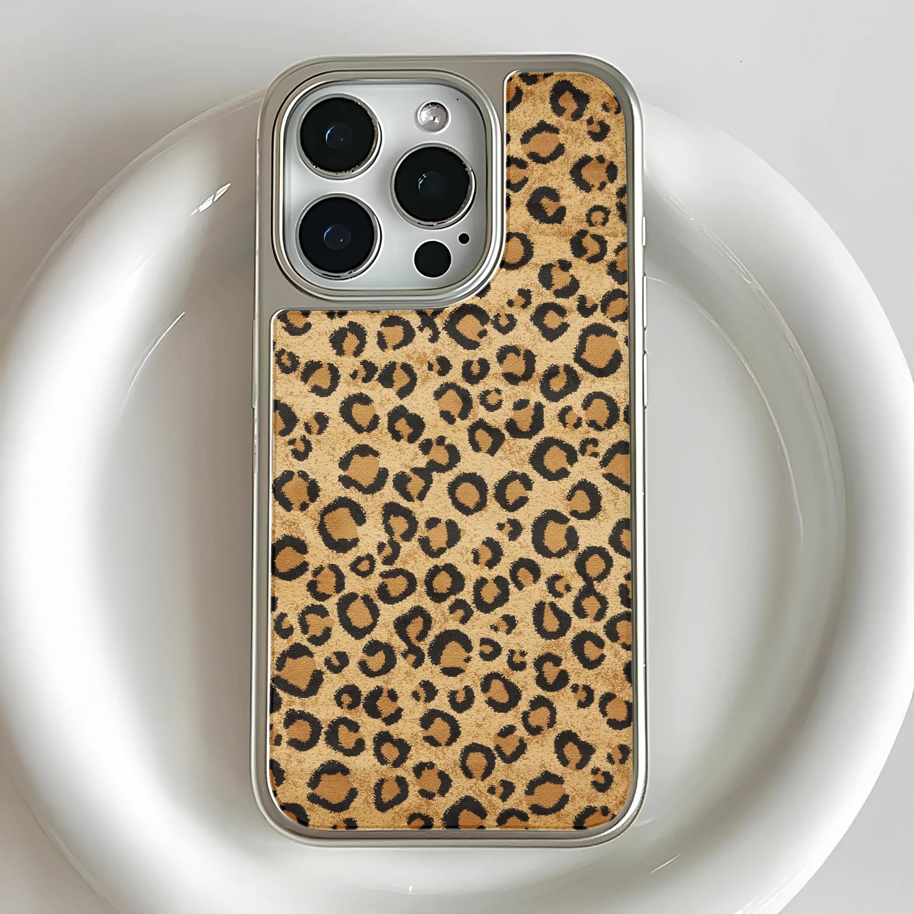 Silver phone case with tan leopard print back, close-up rear camera angle