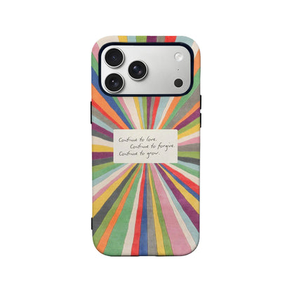 Colorful sunburst illustration with an inspirational handwritten note in the center reading: "Continue to love. Continue to forgive. Continue to grow.