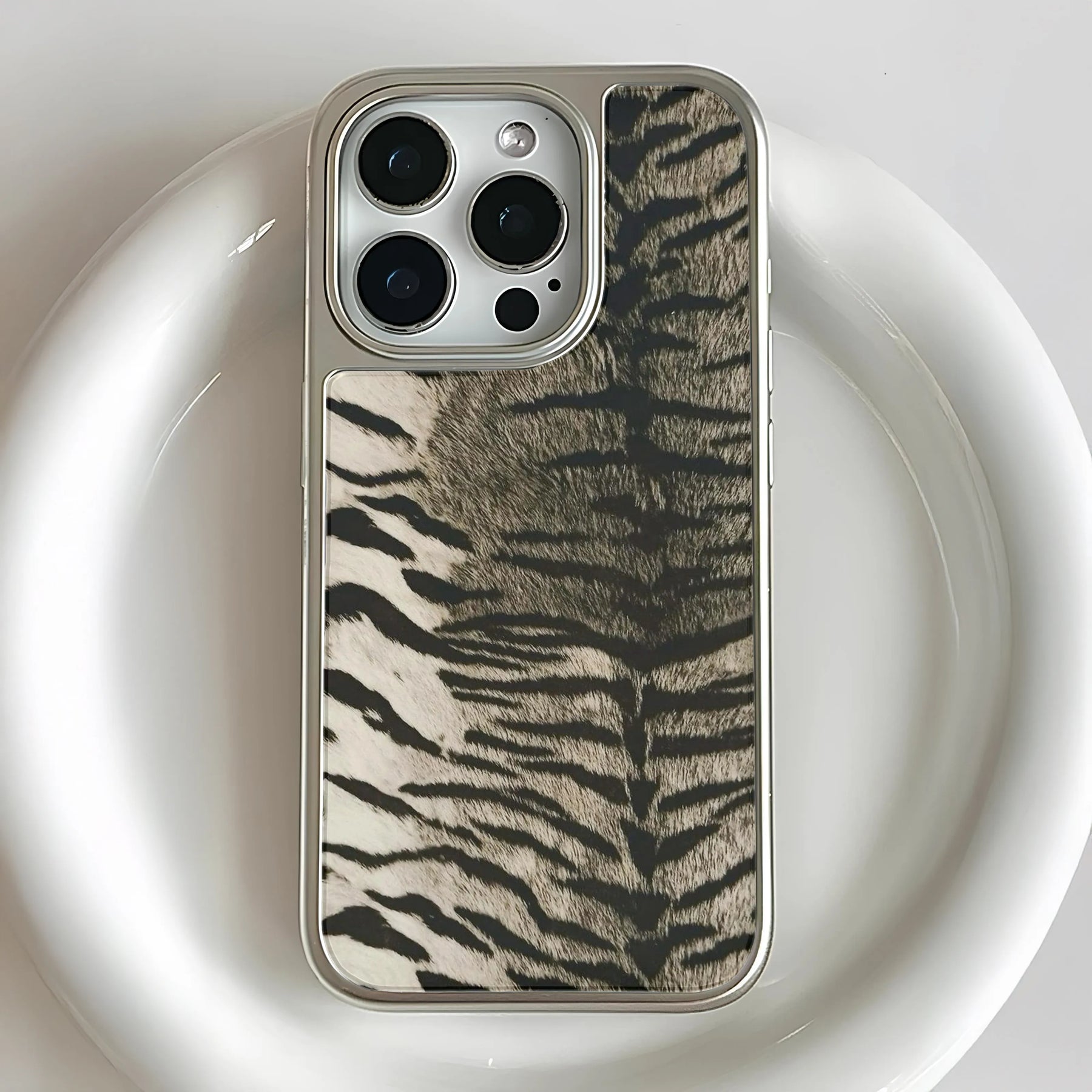 Silver-edged zebra print phone case shown close-up from rear for Shopify product page