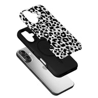 Black and white leopard print phone case angled above smartphone back