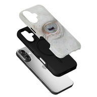 White cow eye print phone case over black case and silver smartphone, angled product display