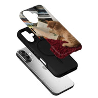 Black phone case with cat reading book print shown in angled exploded product view