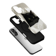 Black phone case with black cat in white plastic bag, angled on silver smartphone