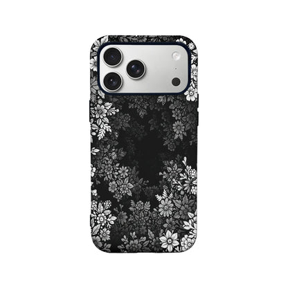 Black floral phone case shown from back with white flower pattern and camera cutout