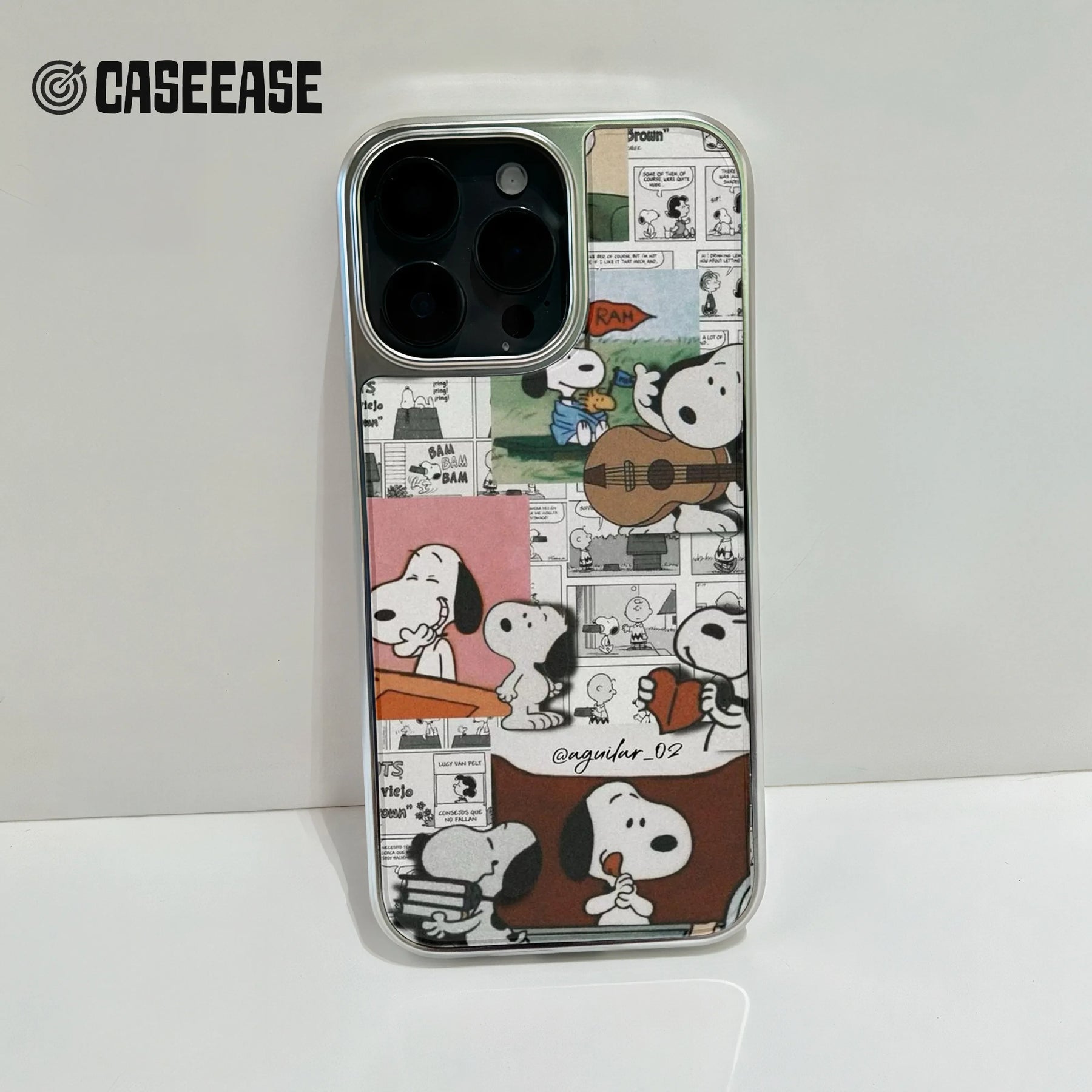 Silver-edged phone case with colorful Snoopy comic collage, rear close-up product shot