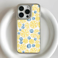 Silver smartphone case with lemon and blueberry pattern, rear close-up product angle